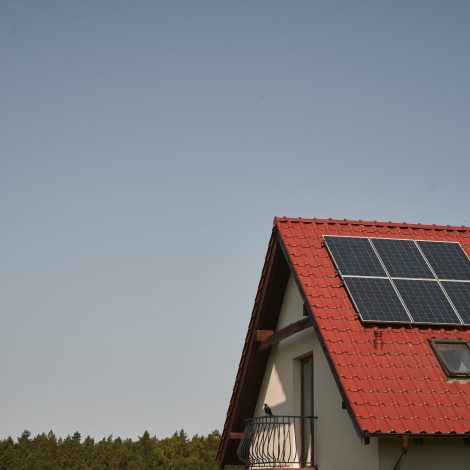 a red roof with a solar panel on it. concept of environmental conservation and sustainable energy sources.